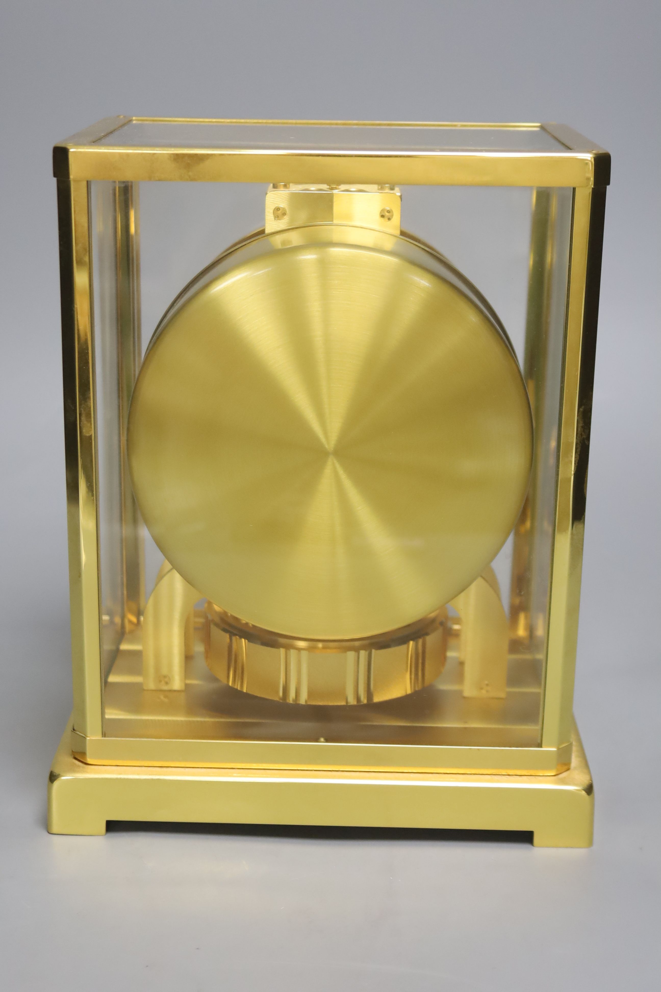 A Jaeger le Coultre Atmos mantel clock, with white enamelled Roman chapter ring, in gilt-brass panelled case, height 22.5cm